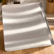 Stainless steel cutting board with edge