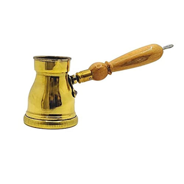 Golden copper cezve with a beige wooden handle